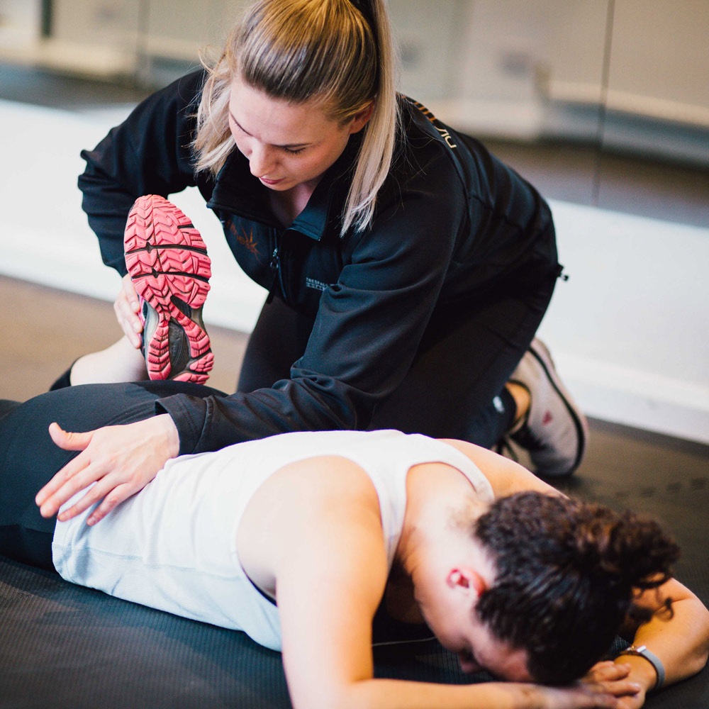 Phoebe Kay stretching her PT client